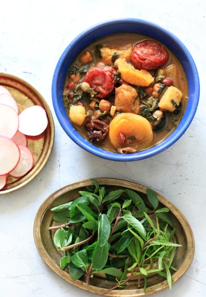 A bowl of hearty stew filled with radishes and assorted vegetables