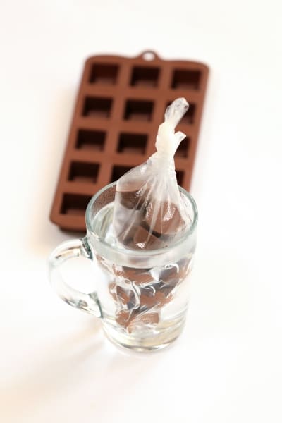 Chocolate-covered marshmallows arranged in a mug, showcasing a delightful treat perfect for cozy moments.