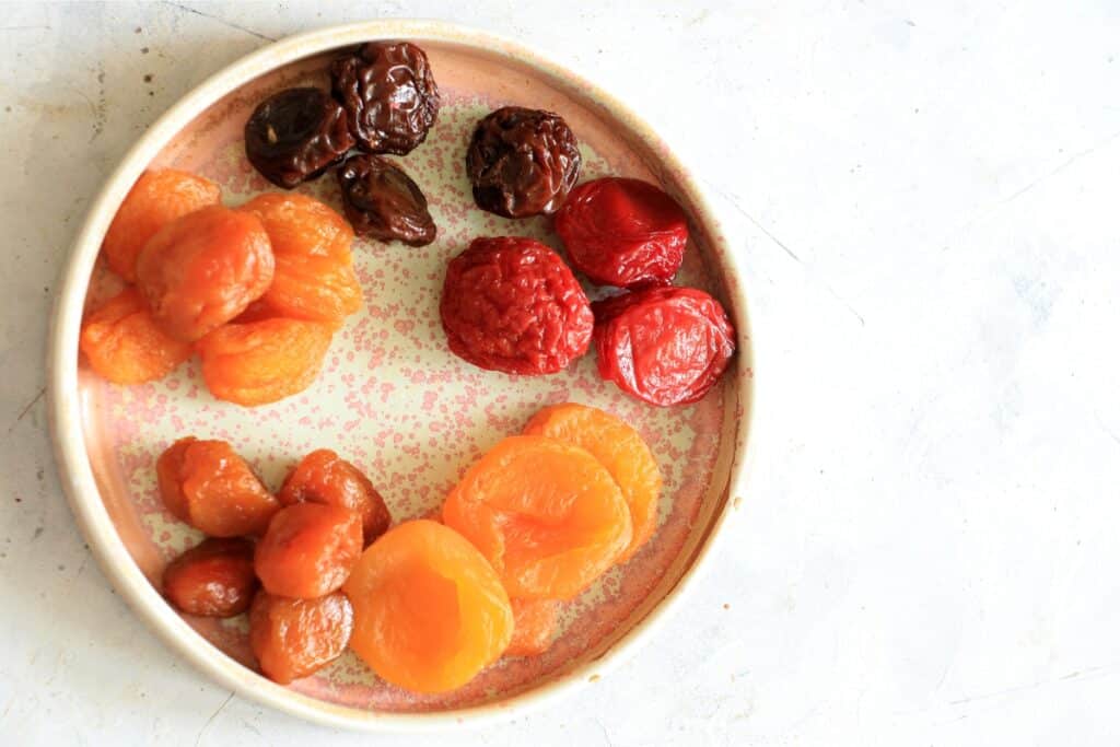 A plate filled with an assortment of colorful dried fruits