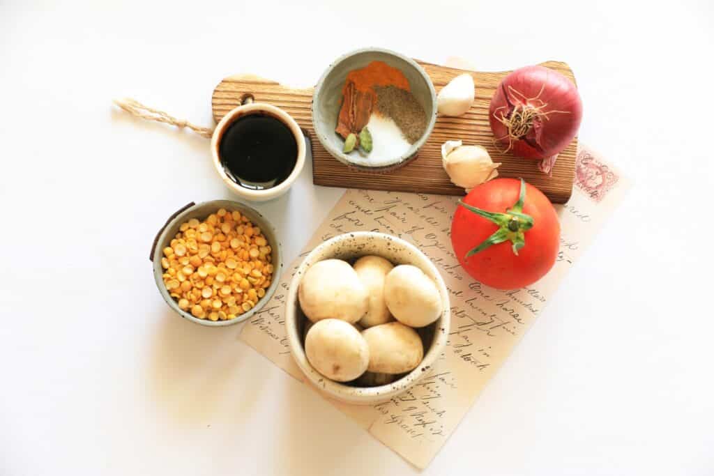 A variety of fresh vegetables, grains, and lean proteins arranged on a wooden table, ready for a healthy meal preparation.